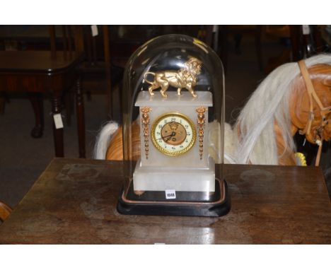 An alabaster cased skeleton dial mantle clock under glass dome.