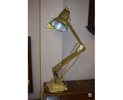 An early 20th Century anglepoise lamp with painted decoration on cream ground.
