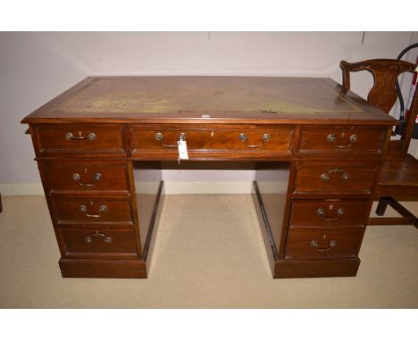 A Georgian style mahogany pedestal desk inset tooled green leather writing surface, 138cms wide.