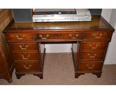 A mahogany pedestal desk with inset tooled green leather writing surface, 122cms.