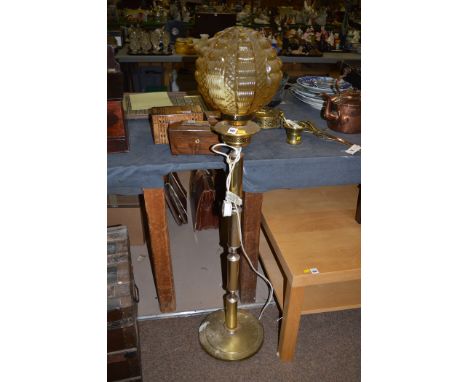 Brushed brass effect standard lamp with amber moulded glass shade.