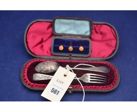 Three 18ct. yellow gold buttons, in fitted case, 4grms; together with a silver spoon and fork, in fitted case.