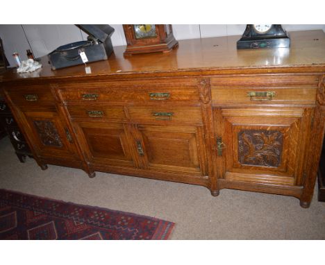 A late Victorian large light oak sideboard, 244cms wide.