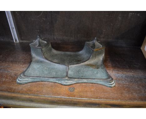 An Art Nouveau patinated brass desk stand, 23cm wide. 