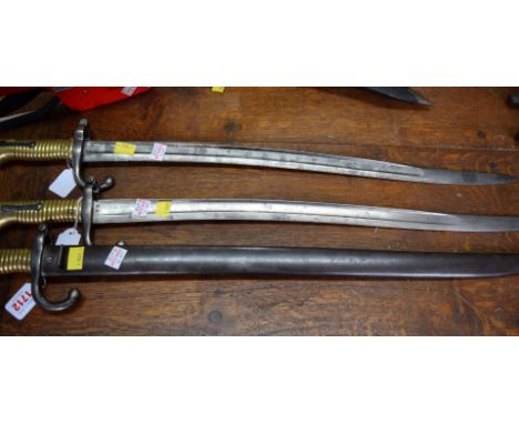 Three 19th century French bayonets, one with steel scabbard; to include a model 1866 Chassepot sword bayonet.