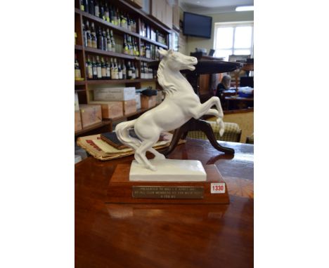 A Goebel white glazed stallion, 27.5cm high, on mahogany plinth with brass presentation plaque. 