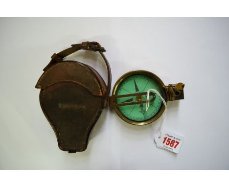A brass military type compass in leather case, by Elliott Bros. 