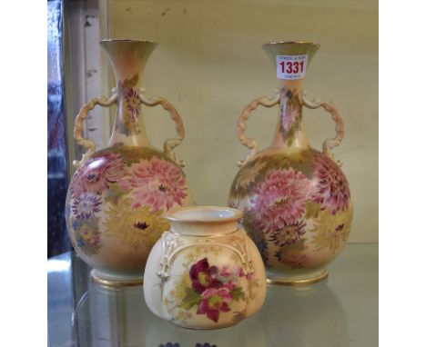 A pair of Carlton ware twin handled vases, 22cm high; together with a Royal Worcester blush ivory globular vase, 8cm high. Co