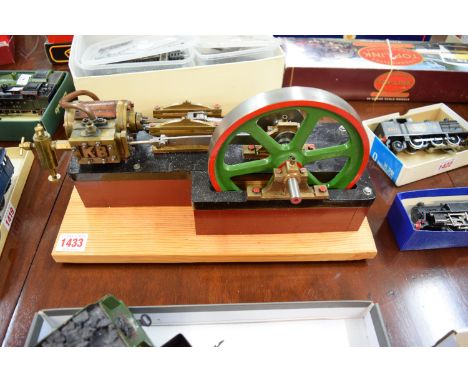 A live steam driven stationery horizontal steam engine, marked K B to cylinder casing, 31cm wide, on pine base. 