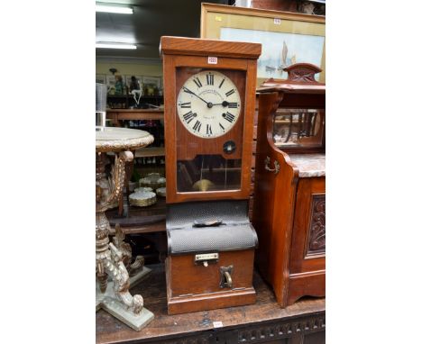 An early 20th century oak 'clocking in' clock, the dial inscribed Time Recorder Supply & Maintenance Co, 98cm high. 