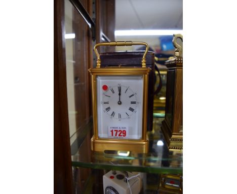A gilt brass carriage clock, repeating on two gongs, strike/silent lever to base, height including handle 17cm, in leather tr
