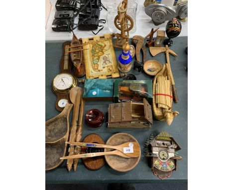 A LARGE QUANTITY OF TREEN ITEMS TO INCLUDE A BAROMETER, SWISS STYLE CLOCK AND HOUSE, A BOAT, BOWLS, ETC 