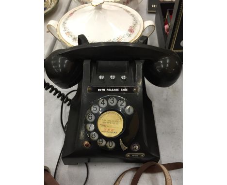 A VINTAGE BLACK BAKELITE ROTARY DIAL TELEPHONE 