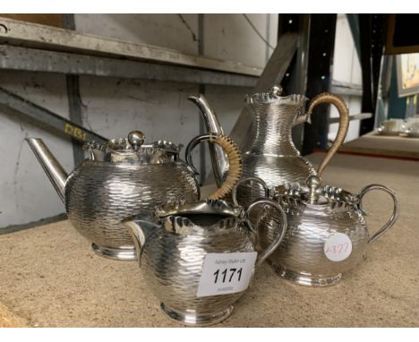 A FOUR PIECE SILVER PLATED TEA SET WITH ABSTRACT DESIGN 