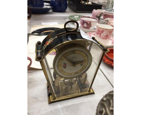 A SMALL GERMAN MANTLE CLOCK WITH FLORAL PATTERN 