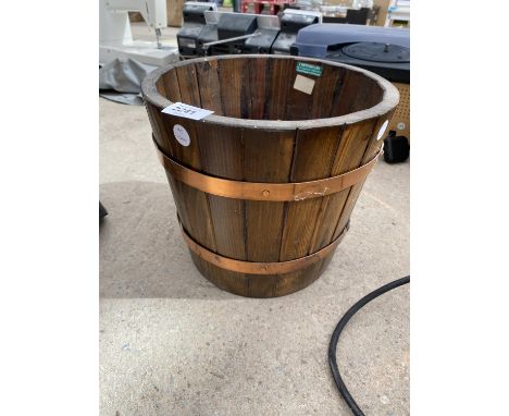A WOOD AND COPPER BANDED GARDEN PLANTER 