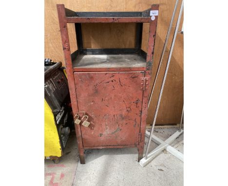 A VINTAGE RED PAINTED METAL TOOL CABINET WITH LOWER DOOR AND UPPER SHELF 