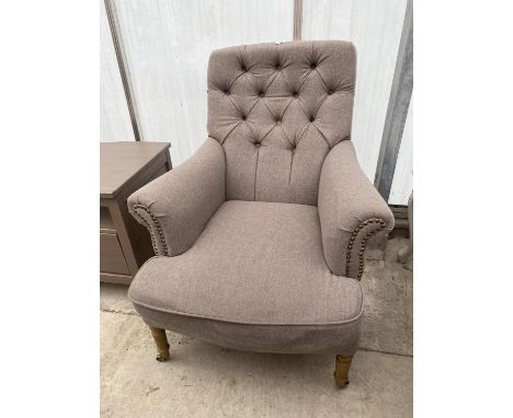 A 'COACH HOUSE ANTIQUE' BUTTON-BACK EASY CHAIR ON TURNED FRONT LEGS 