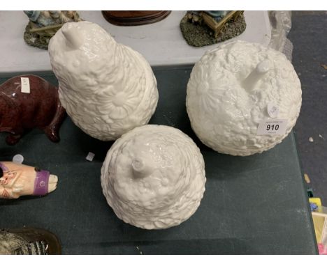 TWO LARGE CERAMIC PEAR AND AN APPLE CANDLE HOLDERS WITH CANDLES 