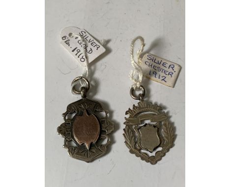 TWO FOBS ONE HALLMARKED CHESTER 1912 SILVER AND THE OTHER SILVER AND GOLD HALLMARKED BIRMINGHAM 1918 