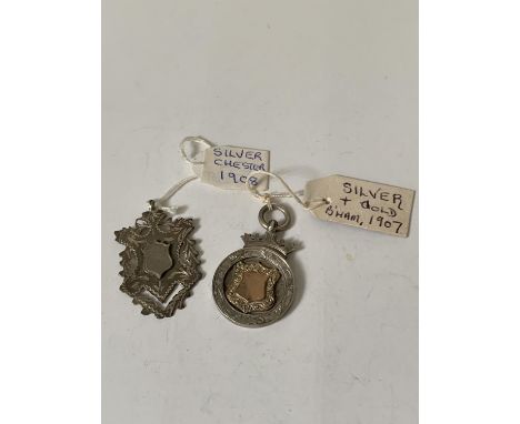 TWO FOBS TO INCLUDE A HALLMARKED CHESTER 1908 SILVER AND A SILVER AND GOLD HALLMARKED BIRMINGHAM 1907 