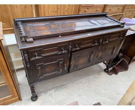 AN EARLY 20TH CENTURY OAK JACOBEAN STYLE SIDEBOARD WITH RAISED PANEL BACK, ON BARLEYTWIST LEGS AND STRETCHERS, 60" WIDE 
