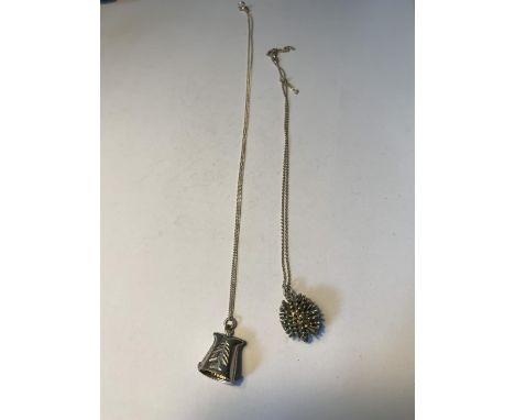 TWO SILVER NECLACES WITH PENDANTS TO INCLUDE A HEDGEHOG AND A BELL 