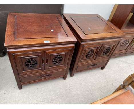 A PAIR OF ASIAN HARDWOOD BEDSIDE CABINETS WITH CARVED PANEL DOORS AND DRAWER TO THE BASE, 20" SQUARE EACH 