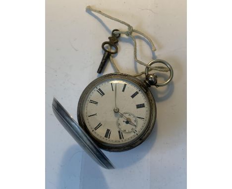 A MARKED 800 SILVER POCKET WATCH WITH WHITE ENAMEL FACE, ROMAN NUMERALS, SUB DIAL AND KEY 
