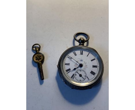 AN 800 SILVER POCKET WATCH WITH SUB DIAL, DECORATIVE WHITE ENAMEL FACE, ROMAN NUMERALS AND A KEY 