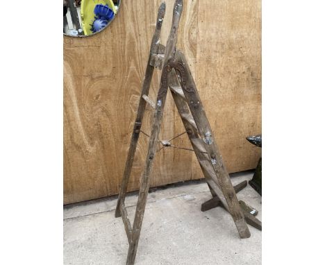 A VINTAGE FIVE RUNG WOODEN STEP LADDER WITH METAL HINGES BEARING THE NAME 'SIMPLEX' 