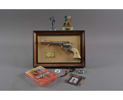 John Wayne Gun / memorabilia, The John Wayne Western Commemorative .45 single action gun mounted in frame, a metal figure wit