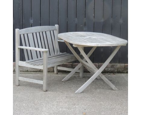 A teak garden table, 135 x 85cm, together with a bench