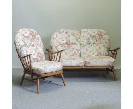 A 1970's Ercol settee and matching armchair, with loose cushions