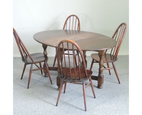 An Ercol dark elm dining table, 108cm, together with a set of four matching spindle back dining chairs