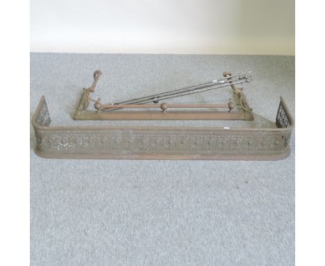 A 19th century brass fender, 133cm wide, together with another smaller and a set of steel fire tools