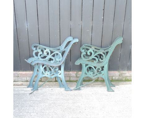 A pair of green painted metal bench ends, together with two other pairs, 60cm