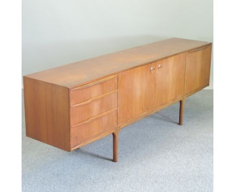 A 1970's teak sideboard by Mackintosh, 214cm, together with a similar teak table, six matching dining chairs and a wall shelf