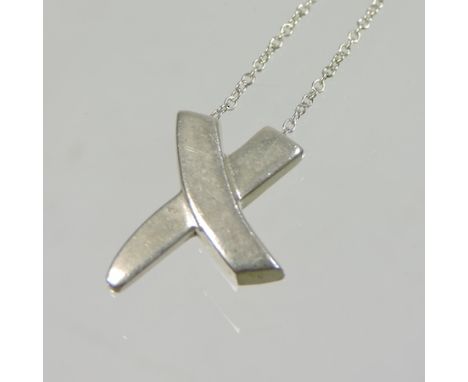 A Tiffany silver kiss shaped pendant, on chain