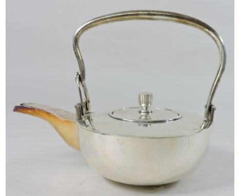 An early 20th century oriental white metal teapot and cover, of compressed circular shape, with a swing handle, Jungin mark t