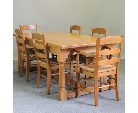 A light oak refectory dining table, 97 x 192cm, together with a set of six ladderback dining chairs