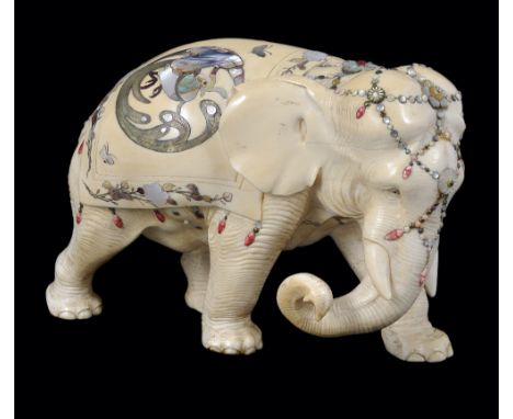 A JAPANESE 'SHIBAYAMA' WORK IVORY FIGURE OF AN ELEPHANT, MEIJI PERIOD (1868-1912) the young beast carved striding and with cu