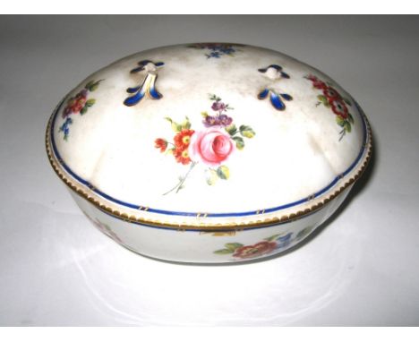 A SEVRES SUCRIER AND COVER, 1764 quattrefoil oval, painted in colours with scattered loose bouquets, blue line with gilt dash