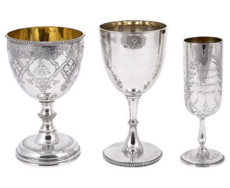 THREE VICTORIAN SILVER GOBLETS the first bright-cut engraved with foliate strapwork and wrigglework borders, crested, monogra
