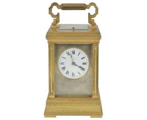 A FRENCH GILT-BRASS CARRIAGE CLOCK, CIRCA 1905 repeating movement striking on a gong, circular white dial with Roman numerals