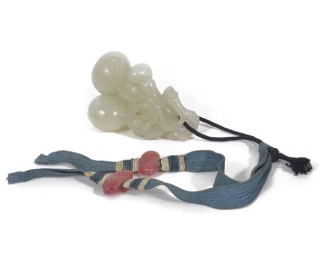 A CHINESE WHITE JADE DOUBLE GOURD PENDANT, 19TH CENTURY a cluster of double gourds with trailing vines, tied with silk band 5