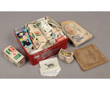 A tin of cigarette and tea cards, loose and in albums to include Wills, Brooke Bond etc.