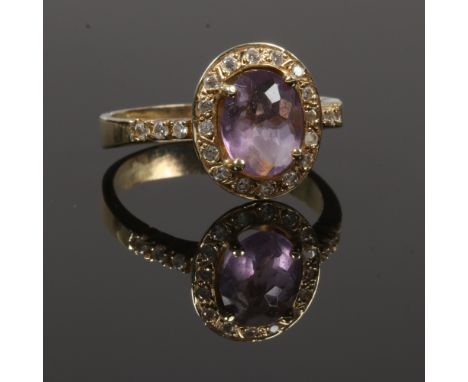 A large 14ct gold amethyst and white paste dress ring.