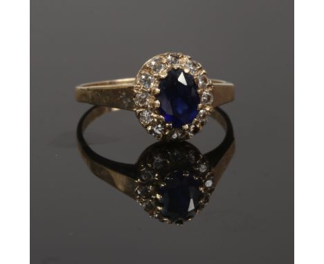 A ladies gold diamond and sapphire cluster ring, size O gross weight 2.58 grams.