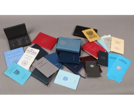 A box of Masonic books including emulation ritual, Nigerian ritual, a Holy Bible and a box of enamel miniatures.